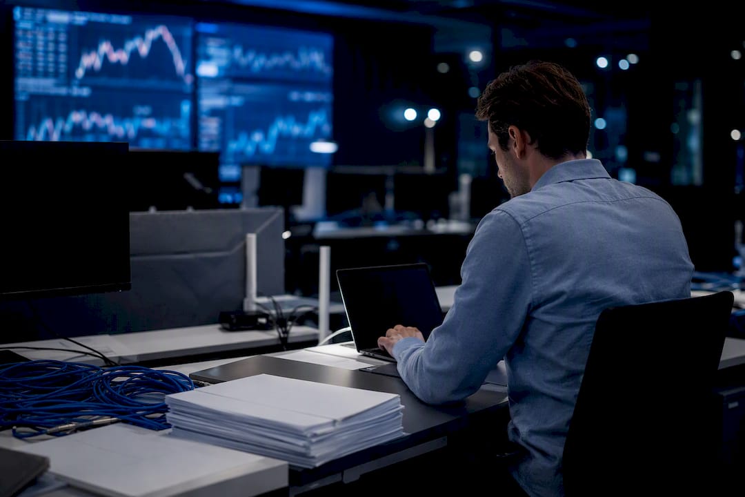 Dark office with glowing monitoring dashboards